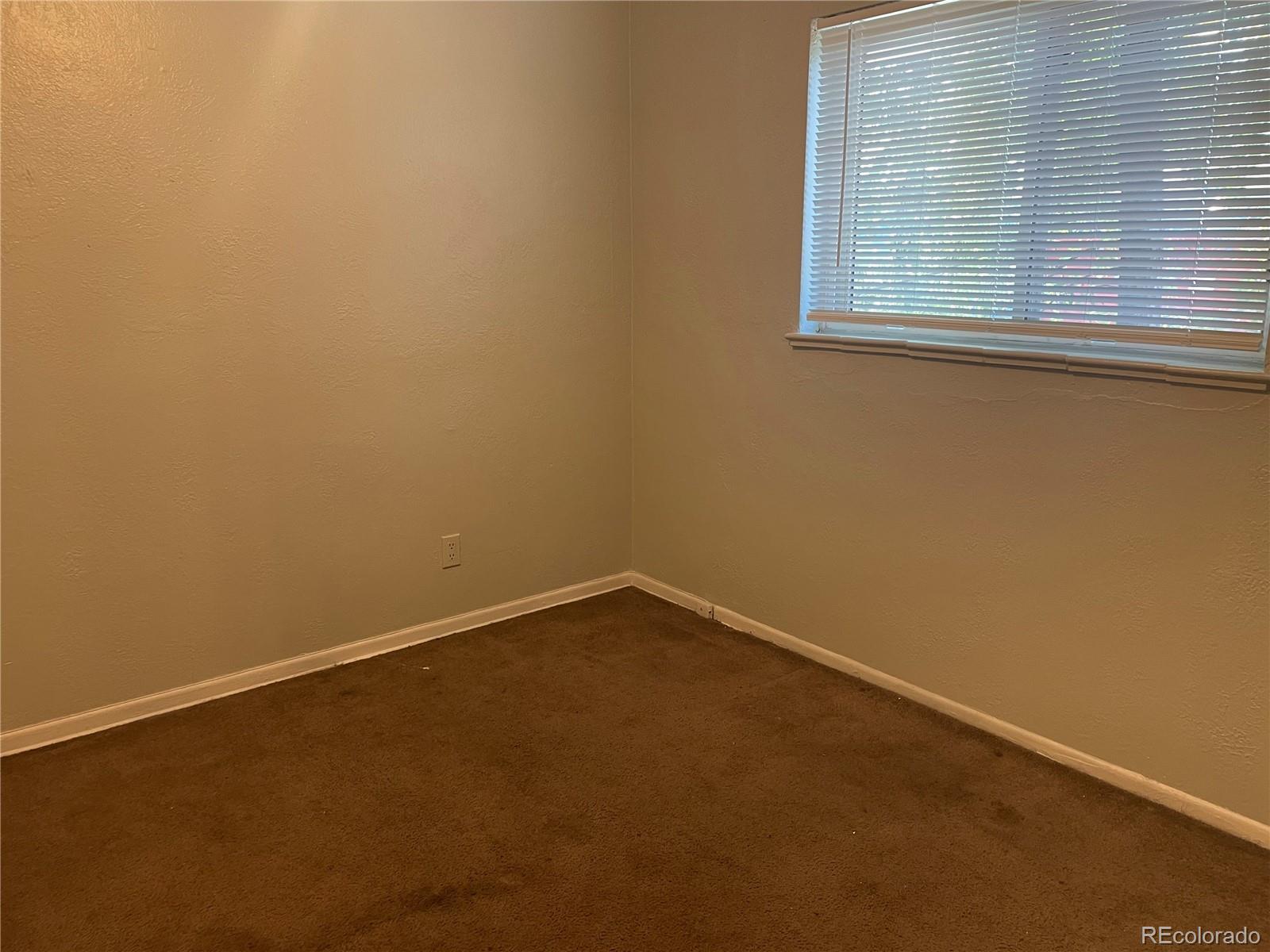 1528 Ulster Street Denver, CO 80220 - Photo 7 of 8 an empty room with a window