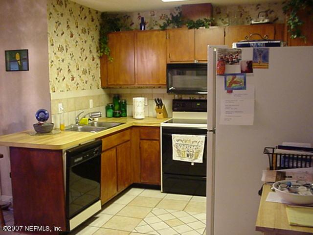 3165 Ricky Drive Jacksonville, FL 32223 - Photo 3 of 8 a kitchen with stainless steel appliances granite countertop a refrigerator stove and sink