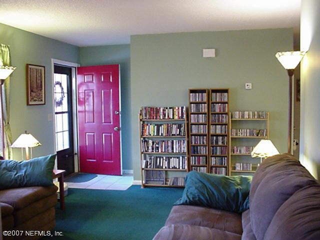 3165 Ricky Drive Jacksonville, FL 32223 - Photo 4 of 8 a living room with furniture and a book shelf