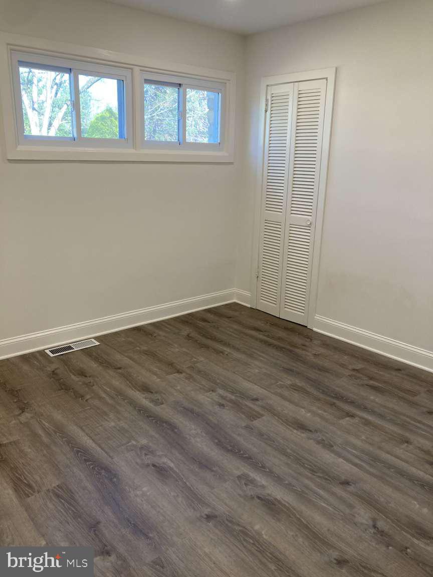806 Rhodes Avenue Jenkintown, PA 19046 - Photo 13 of 16 an empty room with wooden floor and windows