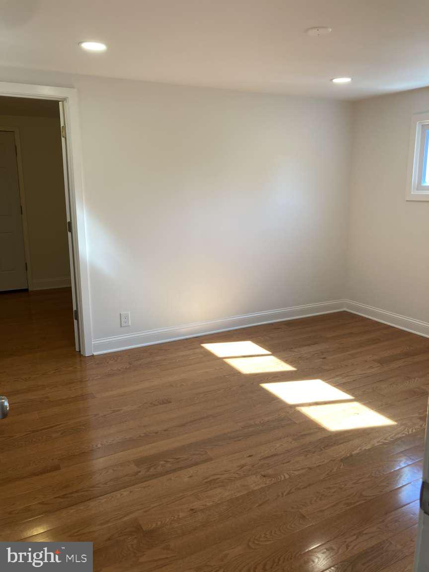 806 Rhodes Avenue Jenkintown, PA 19046 - Photo 14 of 16 en empty room with wooden floor