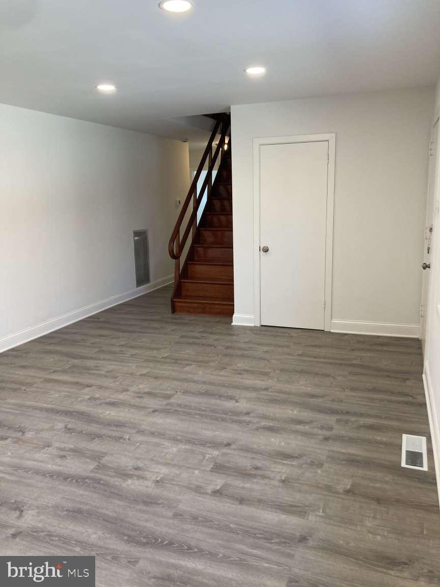 806 Rhodes Avenue Jenkintown, PA 19046 - Photo 2 of 16 a view of an empty room with wooden floor and stairs