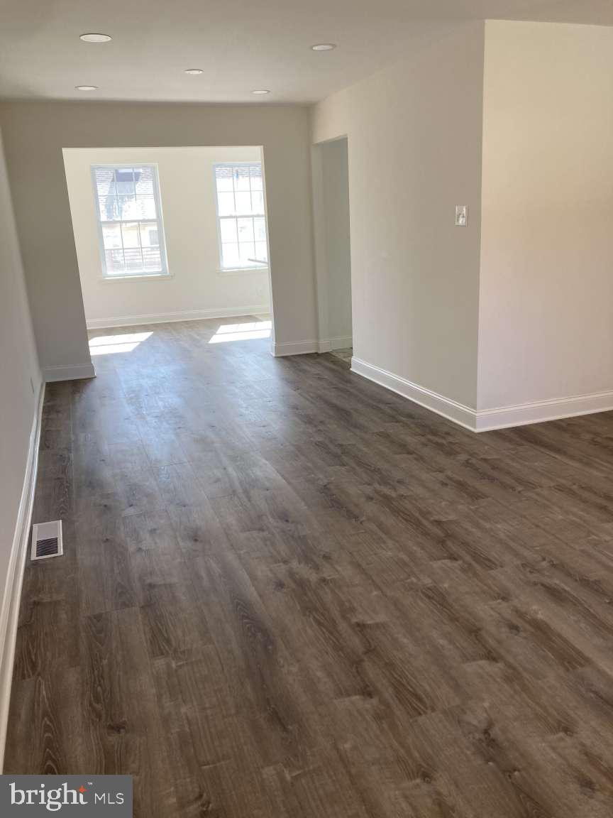 806 Rhodes Avenue Jenkintown, PA 19046 - Photo 3 of 16 an empty room with wooden floor and windows