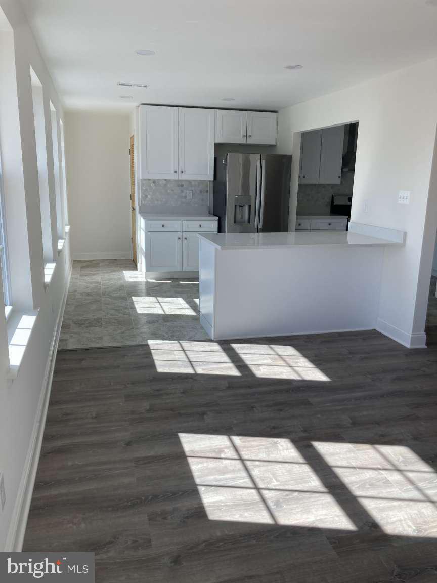806 Rhodes Avenue Jenkintown, PA 19046 - Photo 6 of 16 a kitchen with granite countertop a refrigerator and a stove top oven