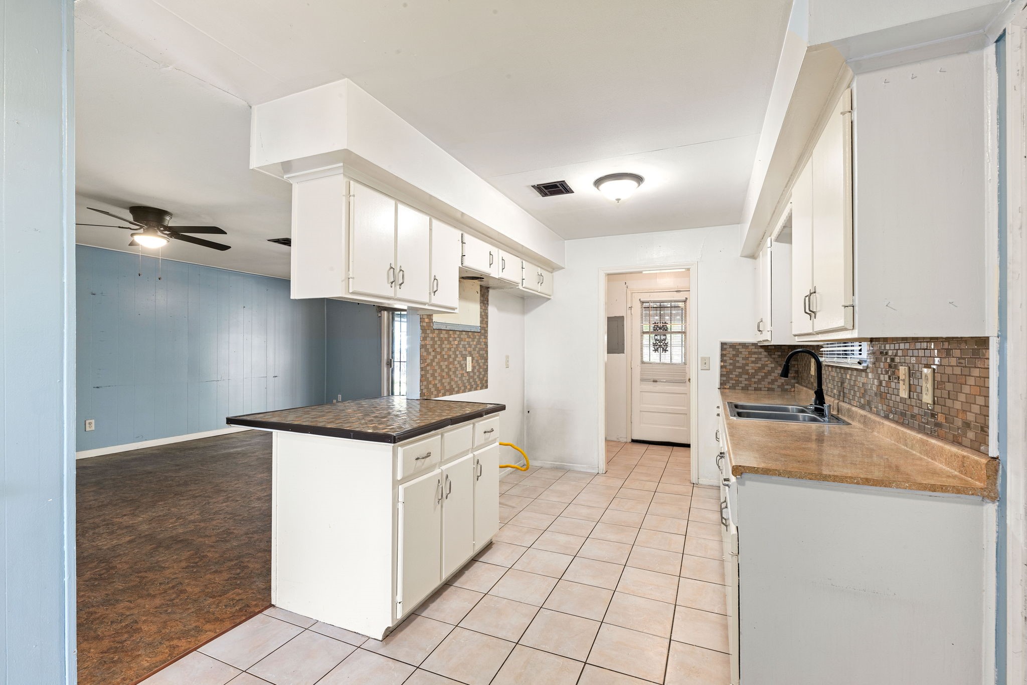 6515 Ashton Street Houston, TX 77091 - Photo 1 of 32 a kitchen with granite countertop a stove top oven and cabinets