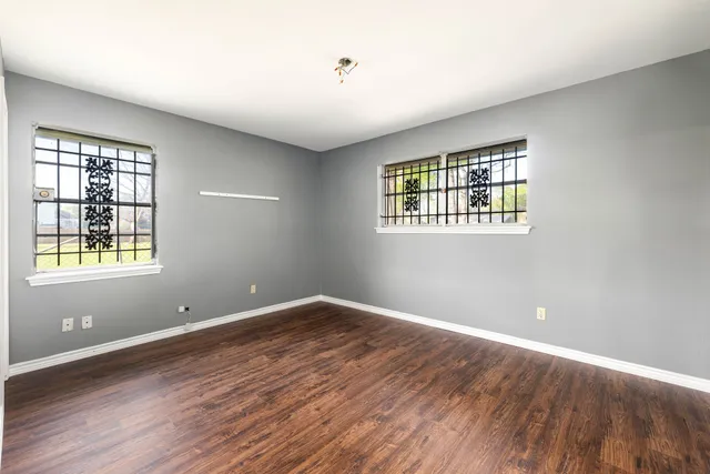 wooden floor in an empty room with a window