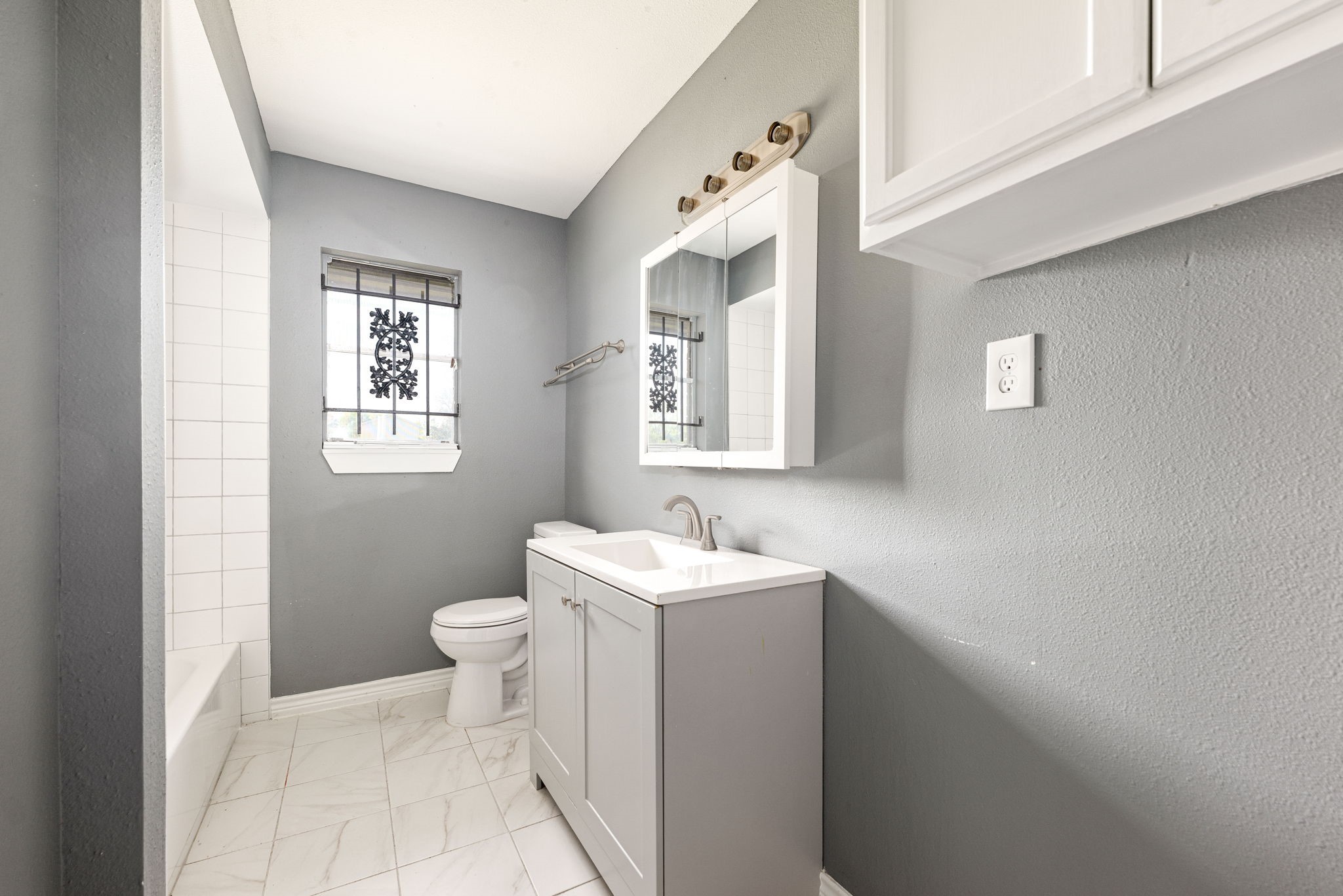 6515 Ashton Street Houston, TX 77091 - Photo 18 of 32 a bathroom with a sink toilet and mirror
