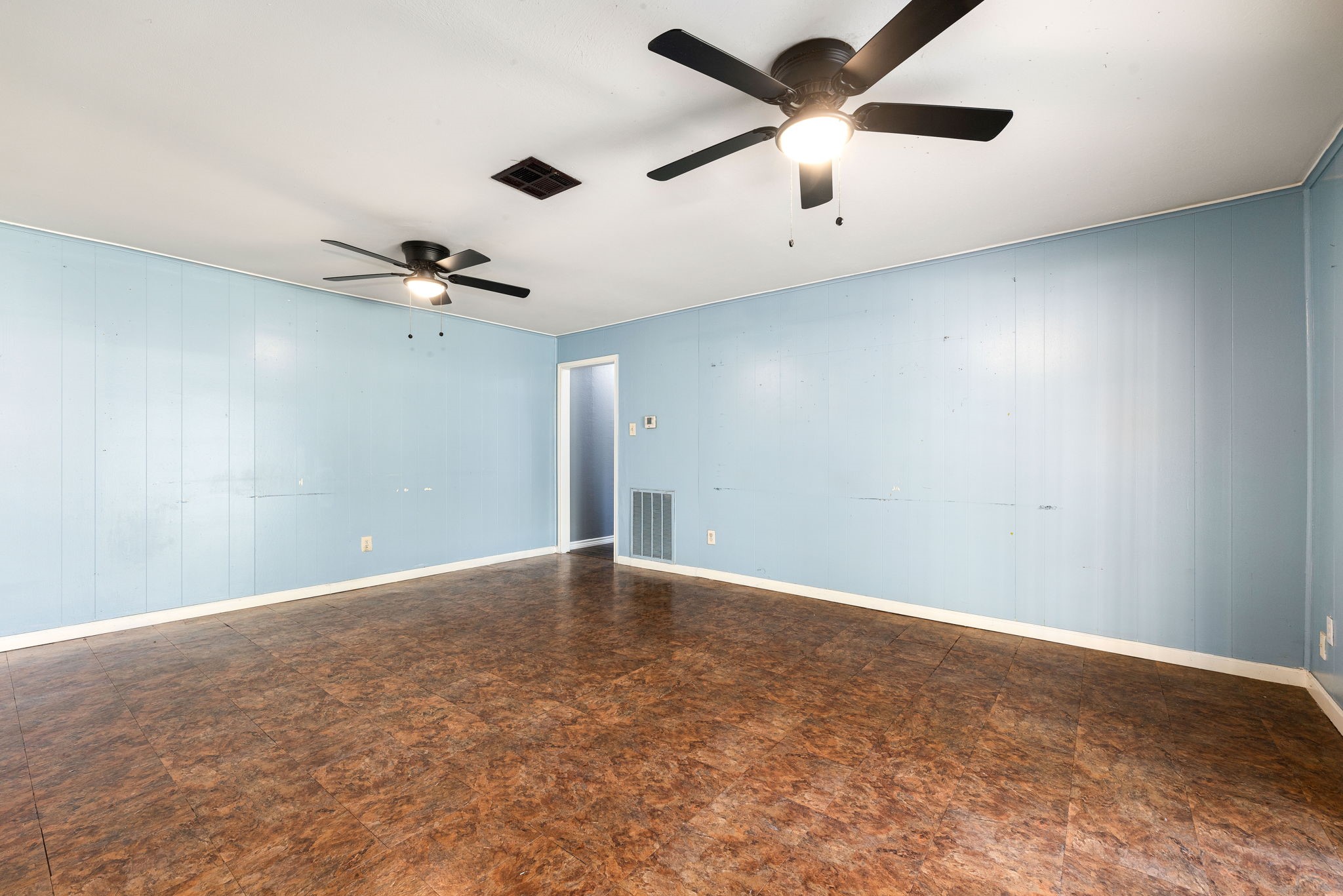 6515 Ashton Street Houston, TX 77091 - Photo 22 of 32 an empty room with a window and a fan