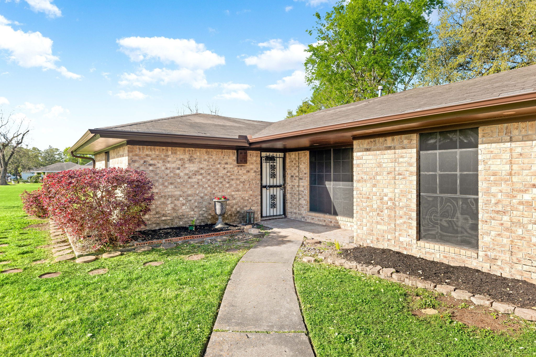 6515 Ashton Street Houston, TX 77091 - Photo 30 of 32 a front view of a house with a garden