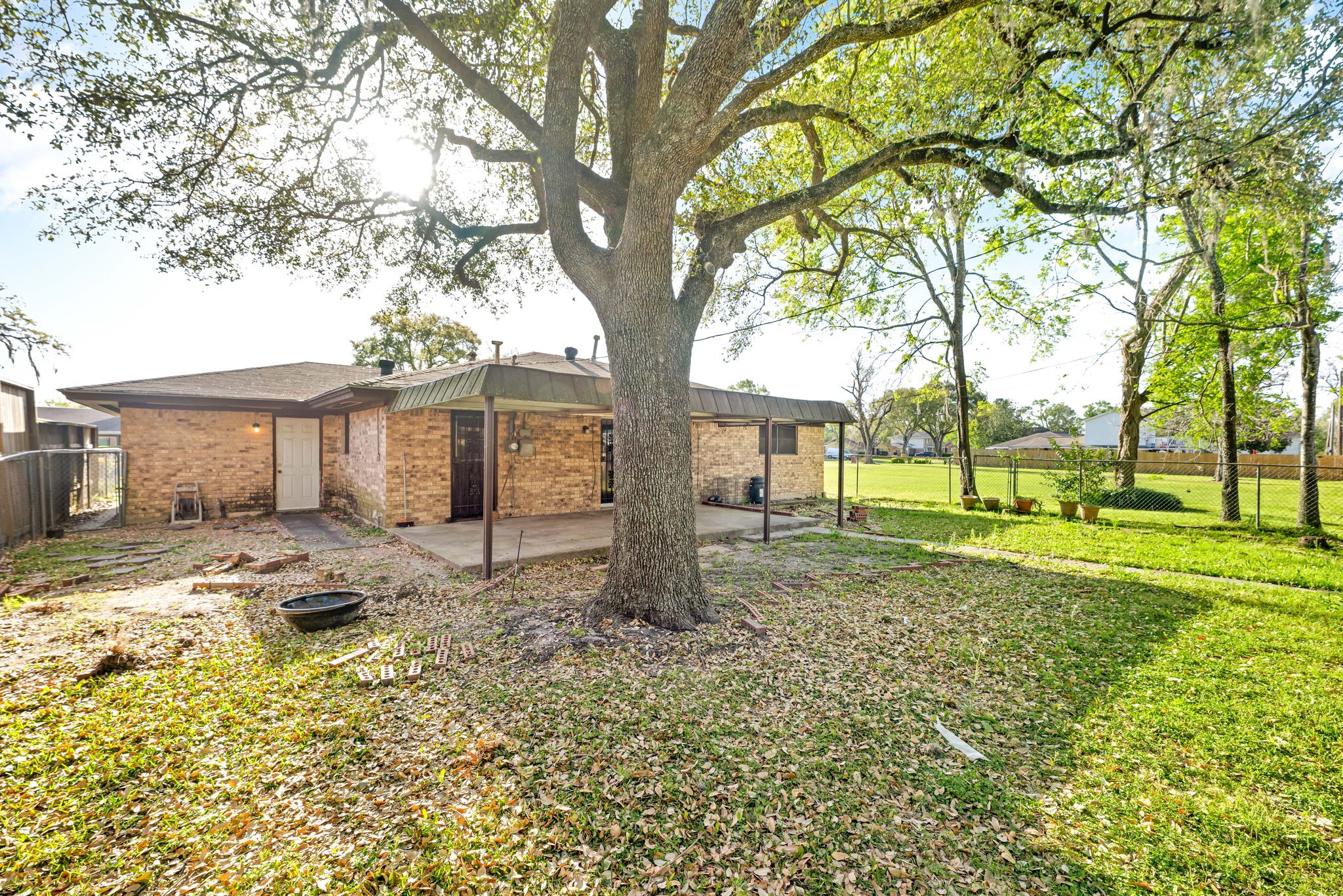 6515 Ashton Street Houston, TX 77091 - Photo 31 of 32 a view of a house with backyard and trees