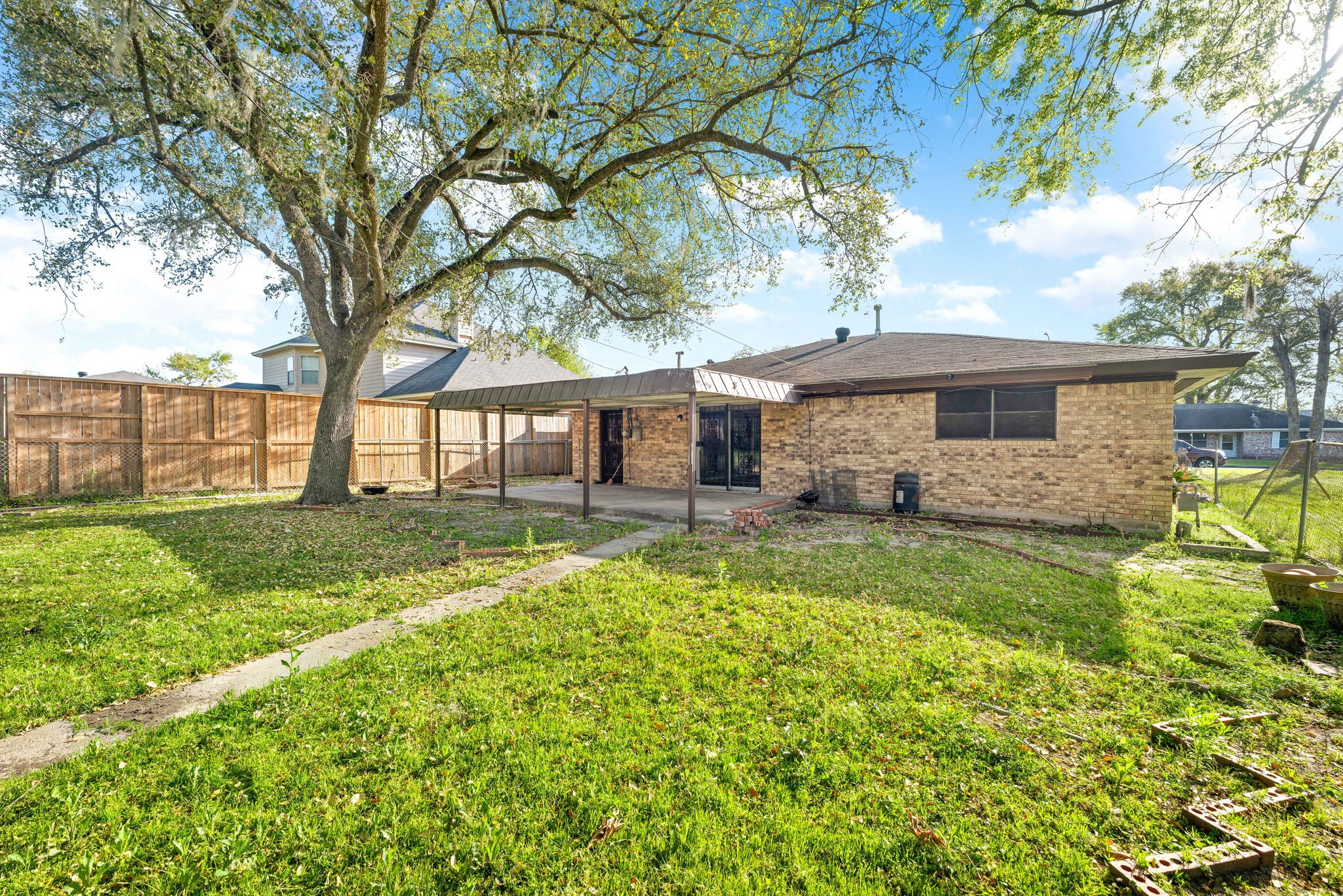 6515 Ashton Street Houston, TX 77091 - Photo 32 of 32 a view of a house with backyard and a tree