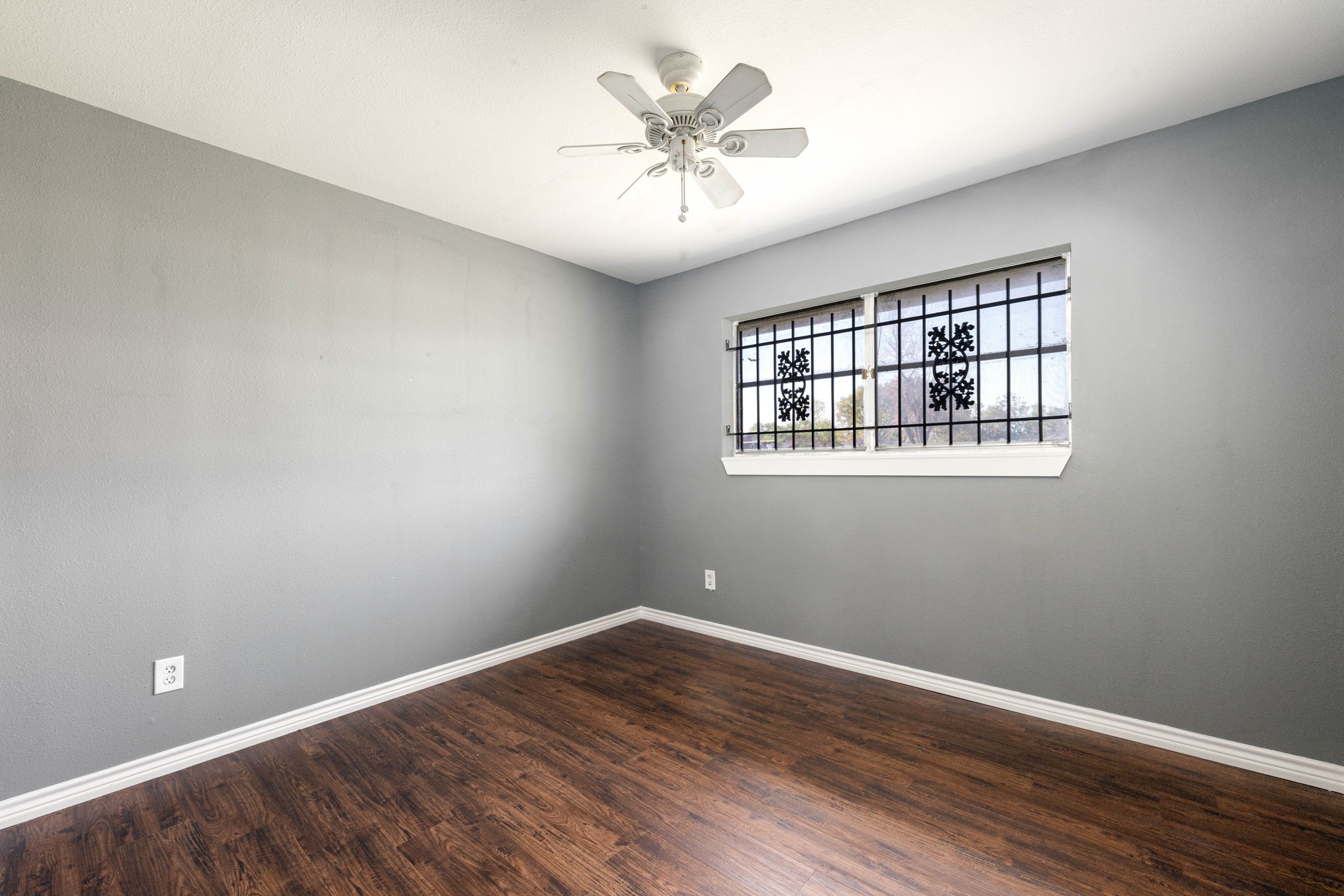 6515 Ashton Street Houston, TX 77091 - Photo 10 of 32 a view of an empty room with window and wooden floor