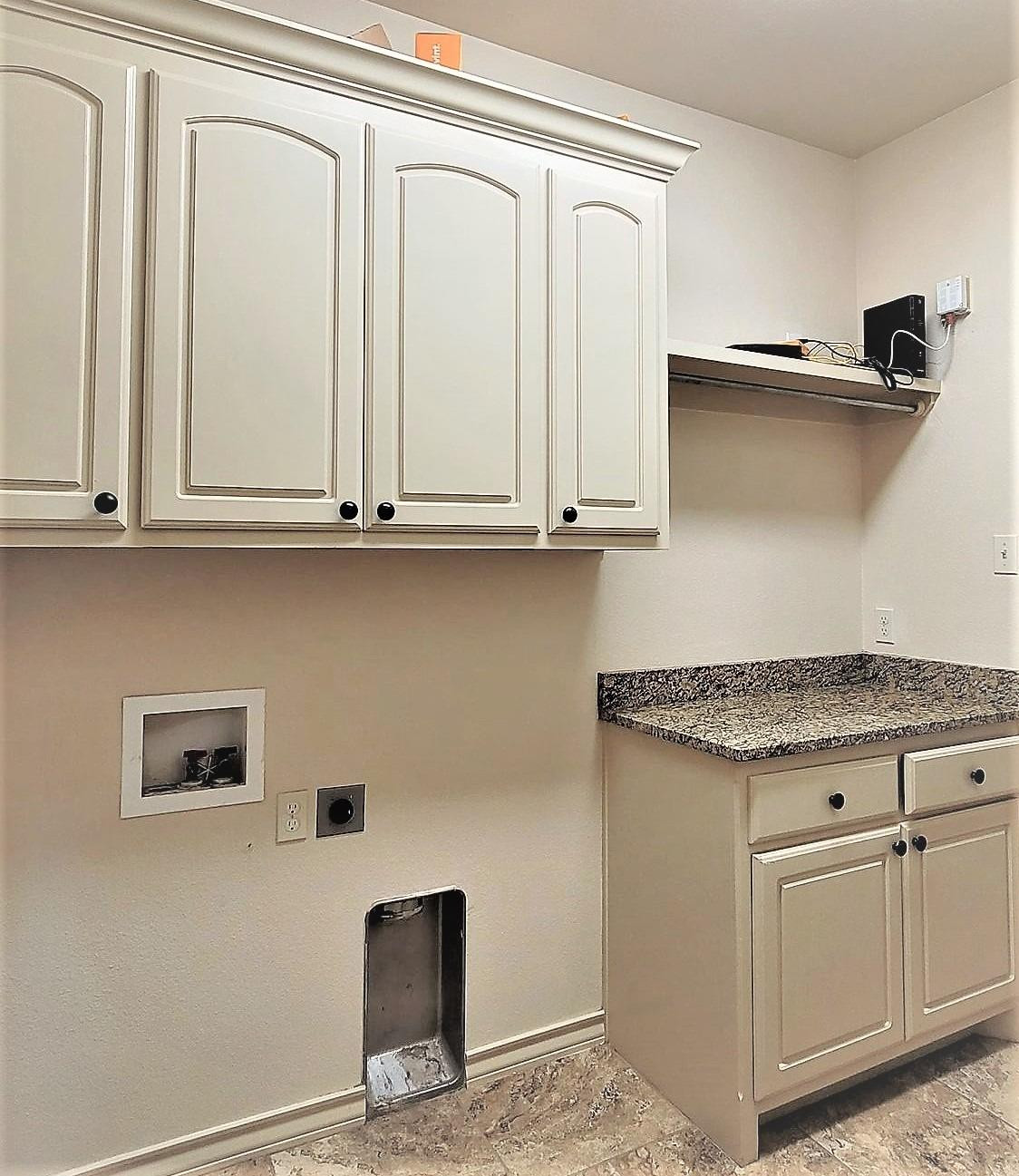 5234 Kemper Street Lubbock, TX 79416 - Photo 20 of 28 a kitchen with granite countertop white cabinets and a sink