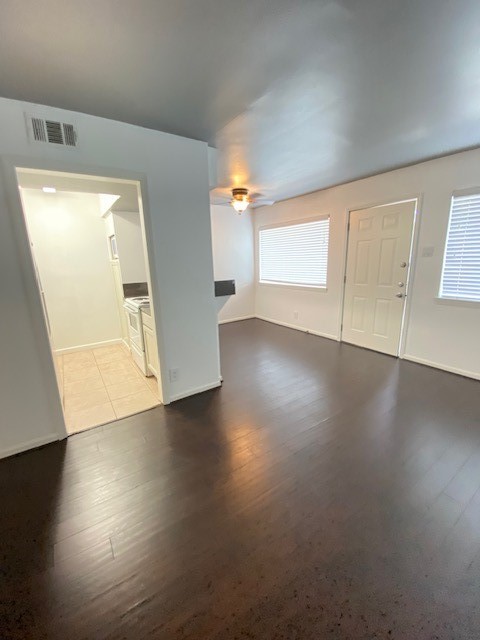 4701 Bell Street, Unit 4 Houston, TX 77023 - Photo 15 of 19 an empty room with wooden floor and windows