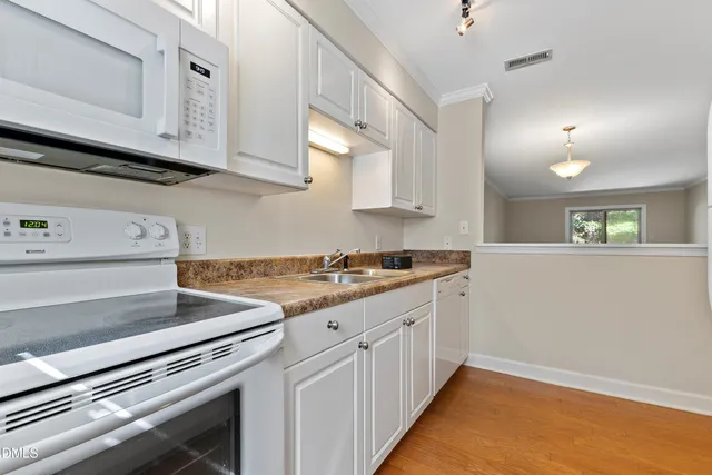 a kitchen with granite countertop a stove and a sink