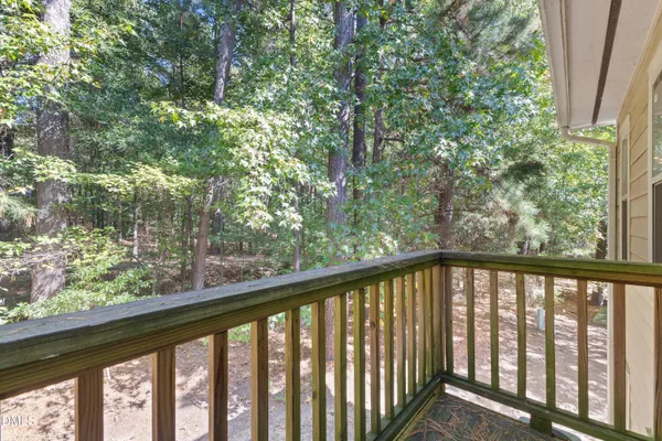 a view of a balcony with trees