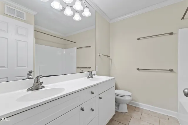 a bathroom with a sink a toilet a mirror and shower