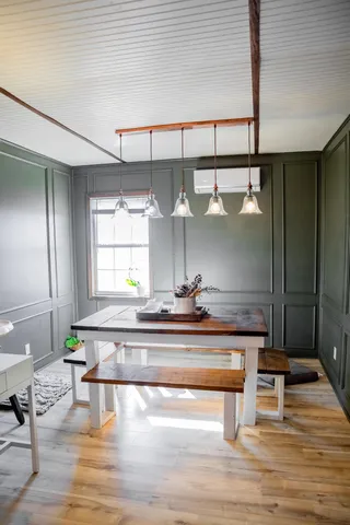 a living room with wooden floor and furniture