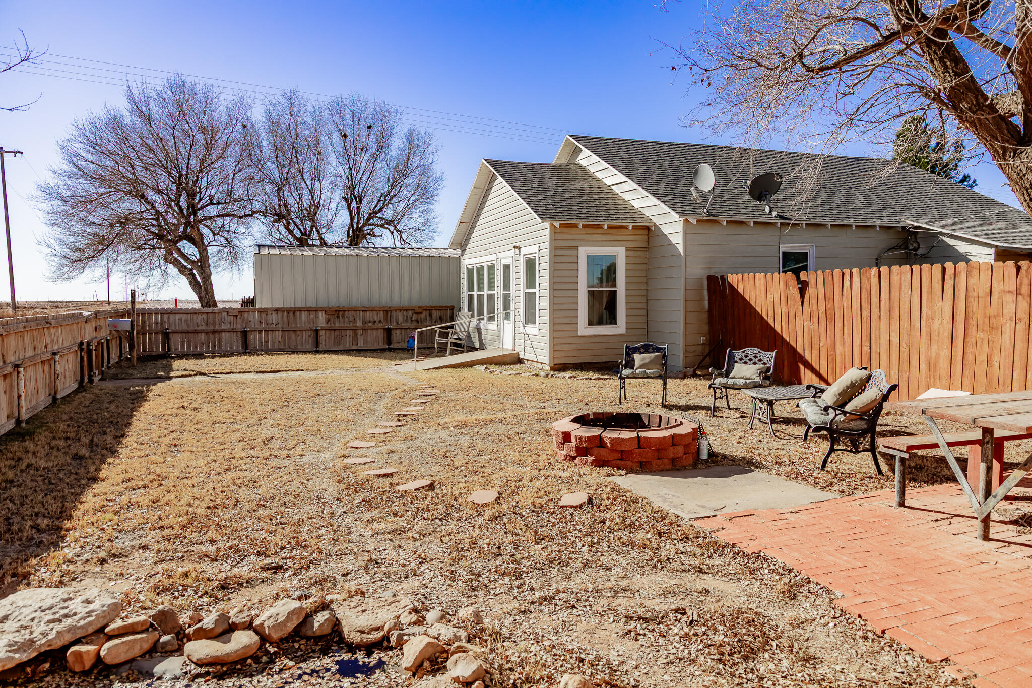 1398 County Road 155 Post, TX 79356 - Photo 3 of 26 a roof deck with table and chairs under an umbrella