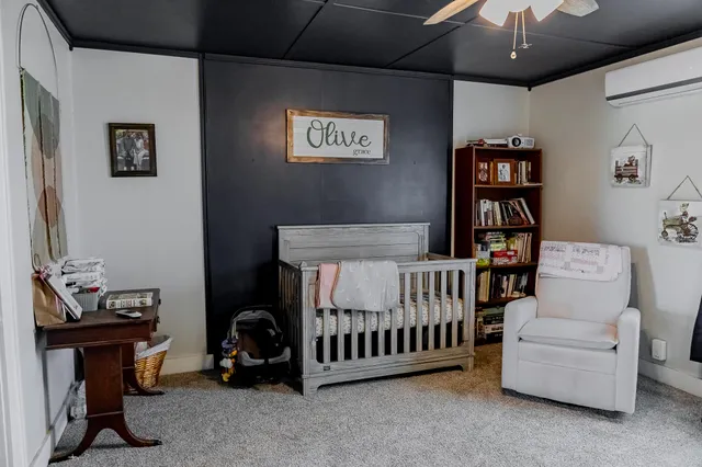 a bedroom with furniture and a window