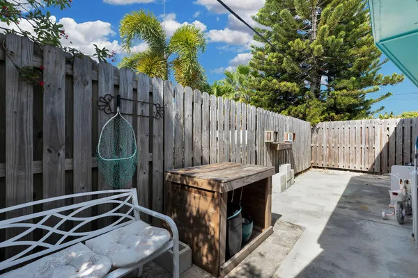 a backyard of a house with table and chairs