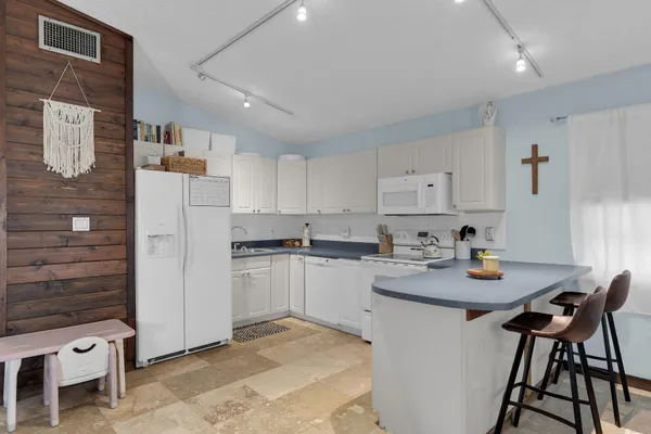 a kitchen with stainless steel appliances granite countertop a refrigerator and a stove top oven