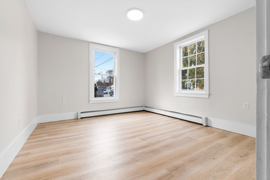 2 Perkins Street Amesbury, MA 01913 - Photo 11 of 36 an empty room with wooden floor and windows