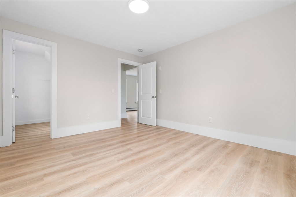 2 Perkins Street Amesbury, MA 01913 - Photo 12 of 36 a view of an empty room and wooden floor