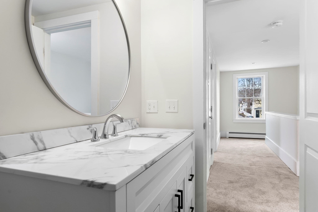 2 Perkins Street Amesbury, MA 01913 - Photo 19 of 36 a en suite bathroom with a sink and a mirror