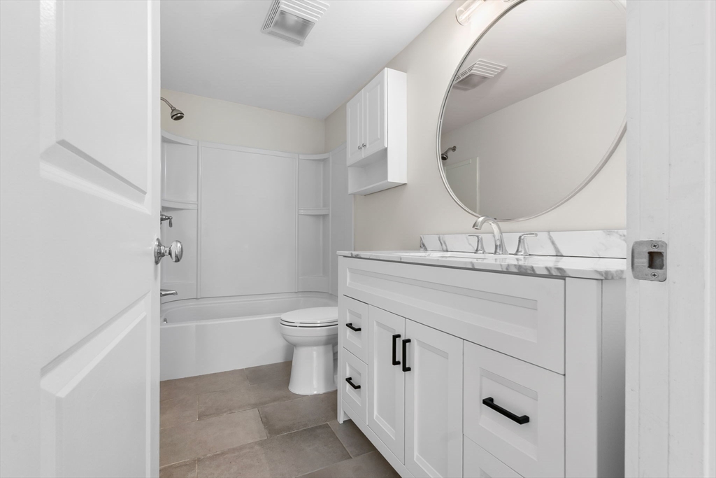 2 Perkins Street Amesbury, MA 01913 - Photo 23 of 36 a bathroom with a sink a toilet and a mirror