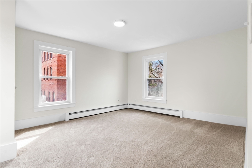 2 Perkins Street Amesbury, MA 01913 - Photo 24 of 36 an empty room with windows and closet