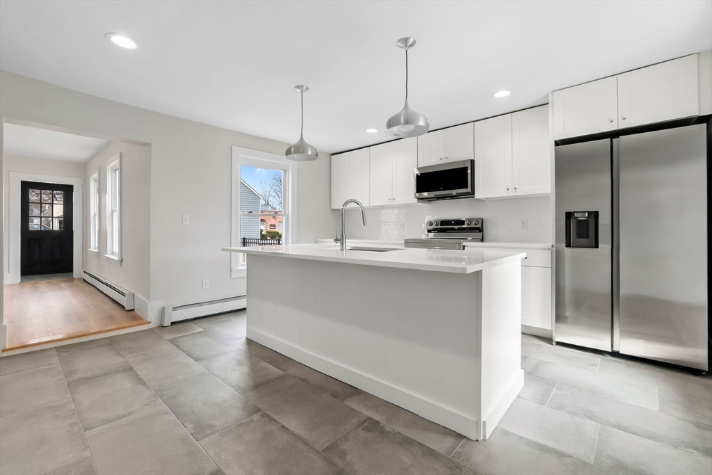2 Perkins Street Amesbury, MA 01913 - Photo 6 of 36 a kitchen with kitchen island a counter top space appliances and cabinets