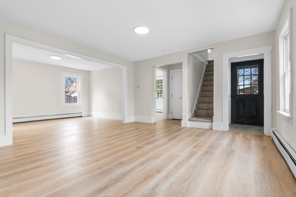 2 Perkins Street Amesbury, MA 01913 - Photo 7 of 36 an empty room with wooden floor and windows
