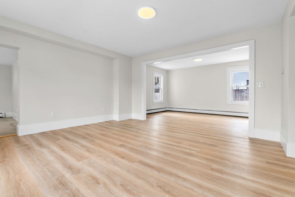 2 Perkins Street Amesbury, MA 01913 - Photo 8 of 36 a view of an empty room with wooden floor and windows