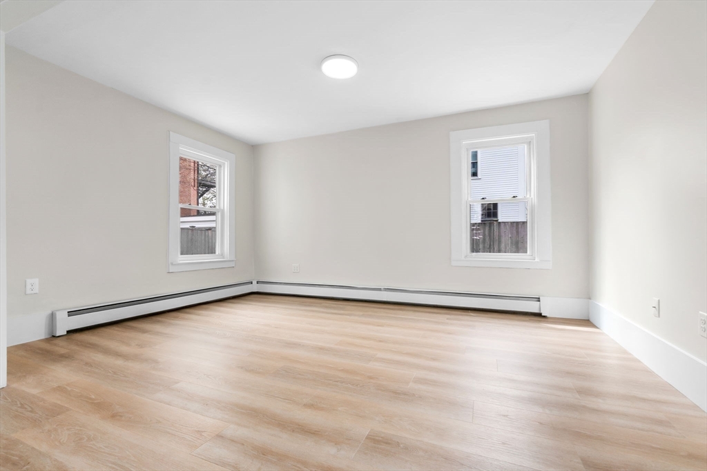 2 Perkins Street Amesbury, MA 01913 - Photo 9 of 36 wooden floor in an empty room with a window