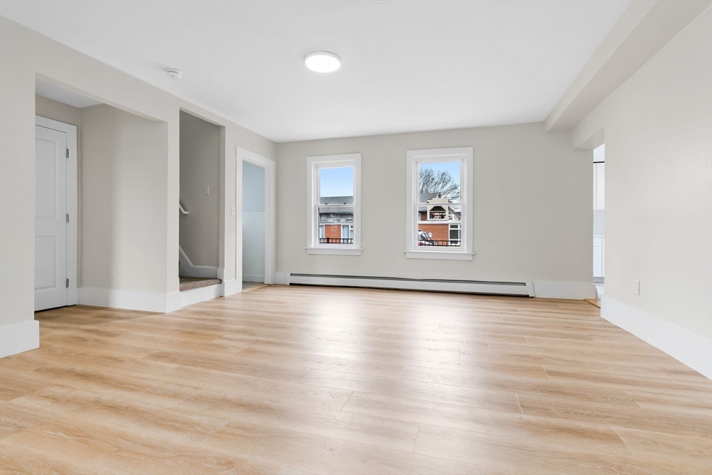 2 Perkins Street Amesbury, MA 01913 - Photo 10 of 36 a view of an empty room with window and wooden floor