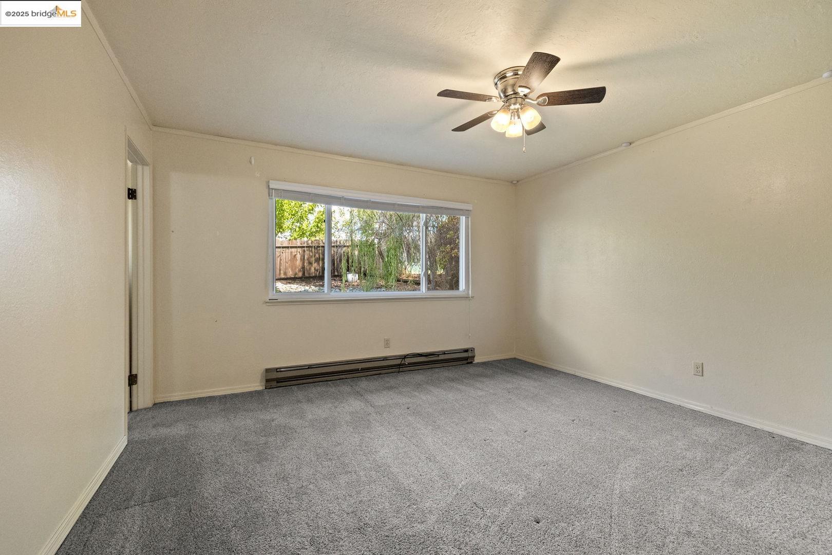 10562 Suzanne Court Jamestown, CA 95327 - Photo 7 of 14 an empty room with fan and windows
