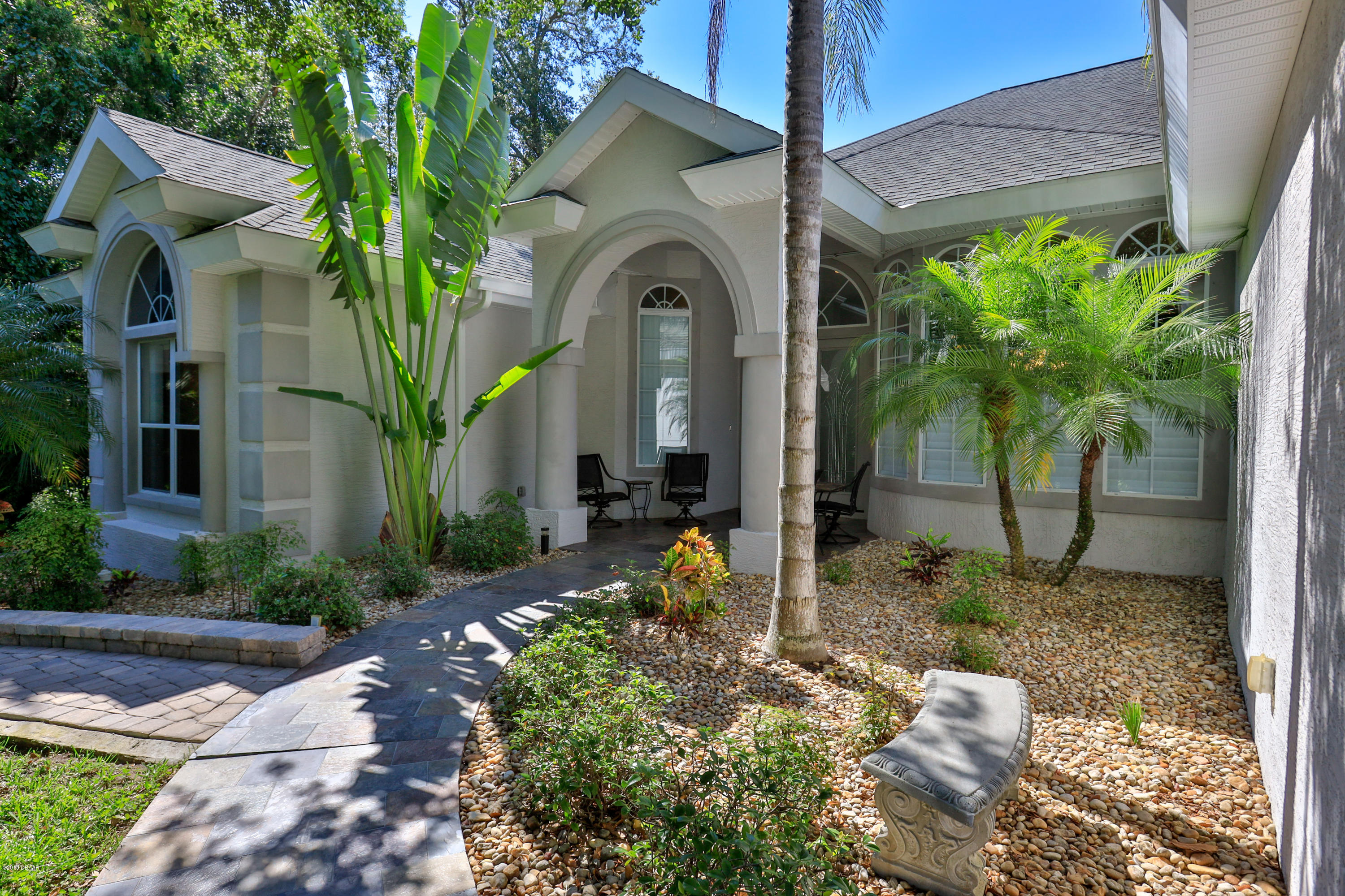 117 Beach Street Ponce Inlet, FL 32127 - Photo 1 of 37 a front view of a house with garden