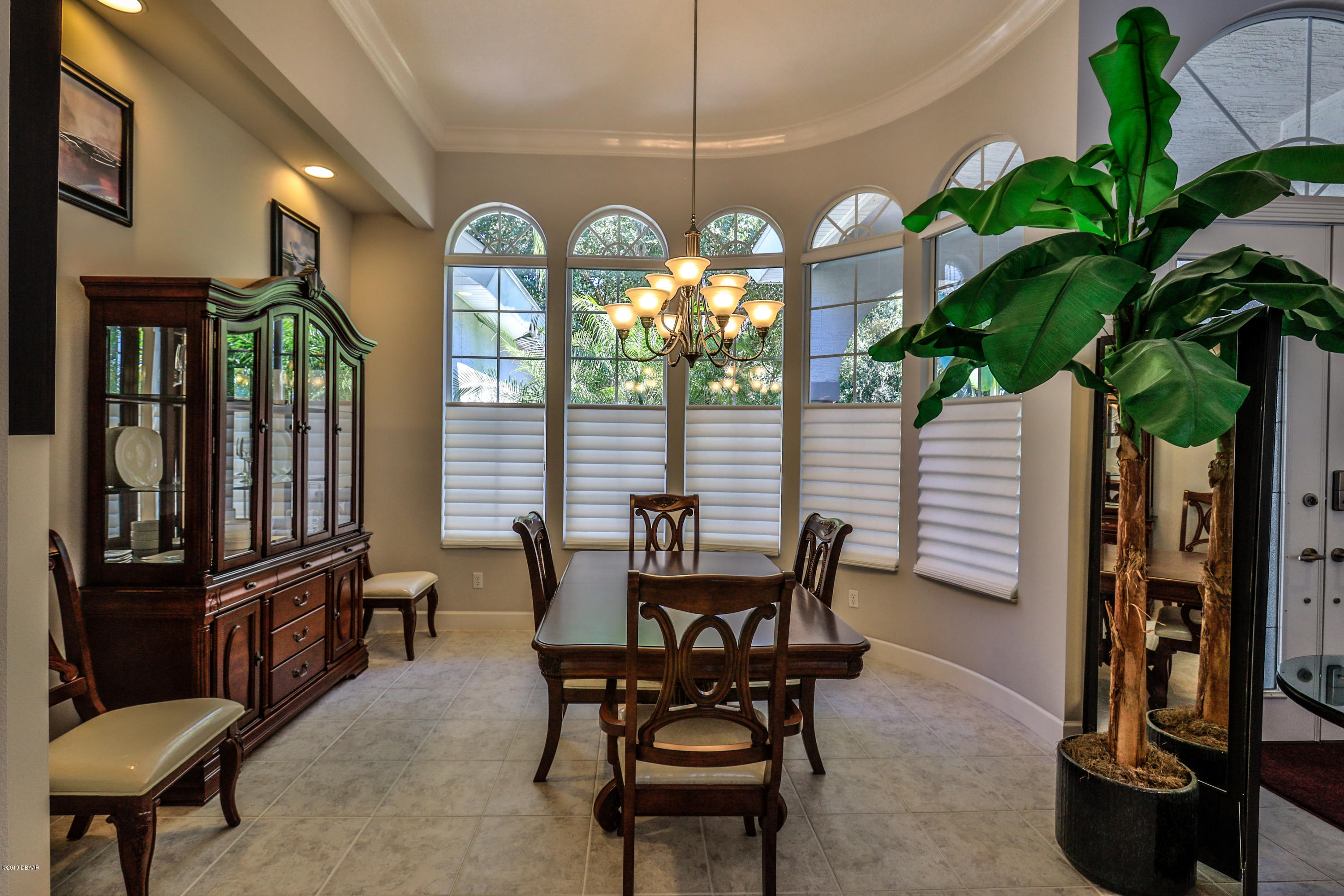 117 Beach Street Ponce Inlet, FL 32127 - Photo 14 of 37 a view of a dining room with furniture and chandelier