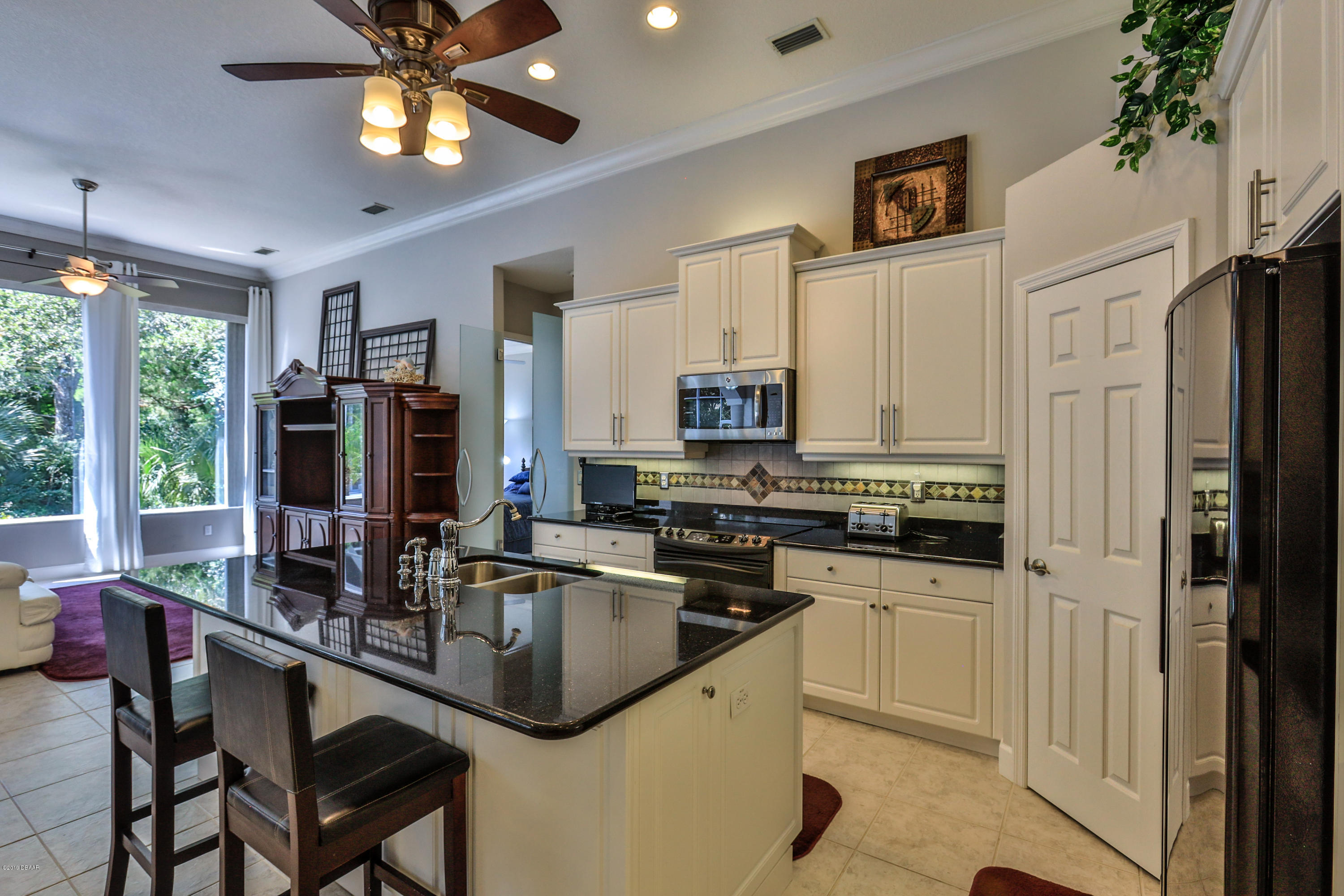 117 Beach Street Ponce Inlet, FL 32127 - Photo 15 of 37 a kitchen with stainless steel appliances granite countertop a sink a stove and a refrigerator