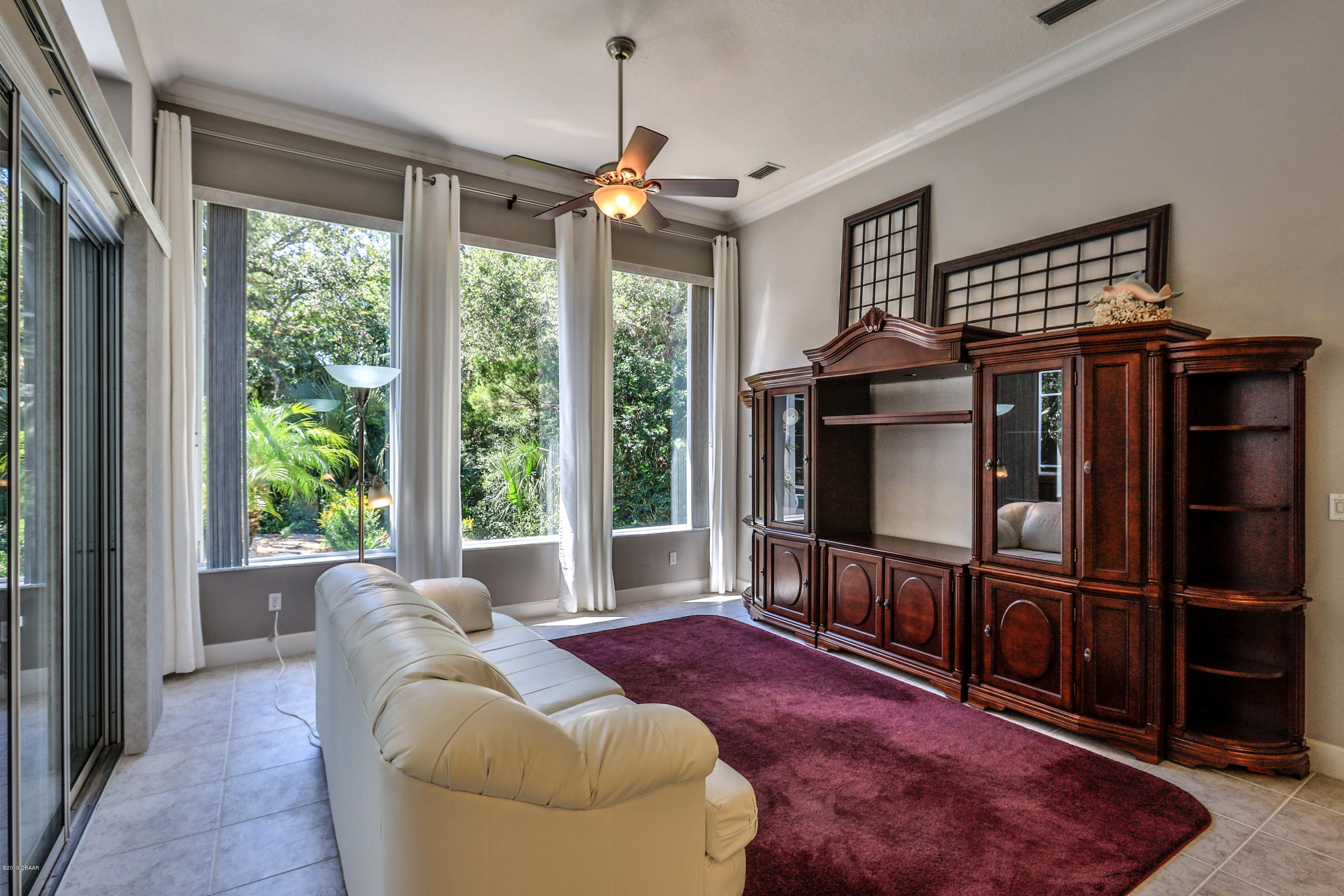 117 Beach Street Ponce Inlet, FL 32127 - Photo 19 of 37 a living room with furniture a window and a flat screen tv
