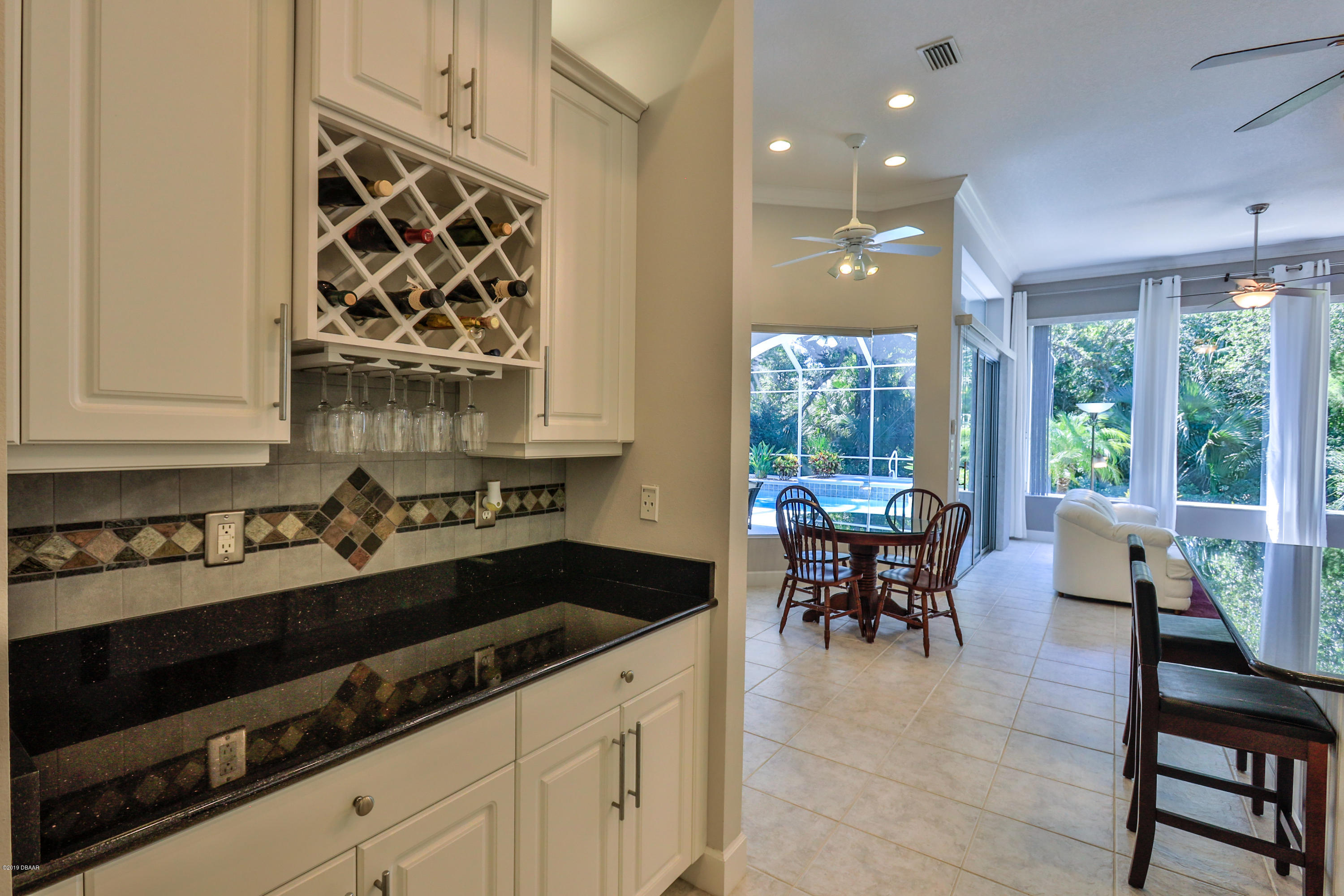 117 Beach Street Ponce Inlet, FL 32127 - Photo 20 of 37 a kitchen with stainless steel appliances a sink stove and dining table