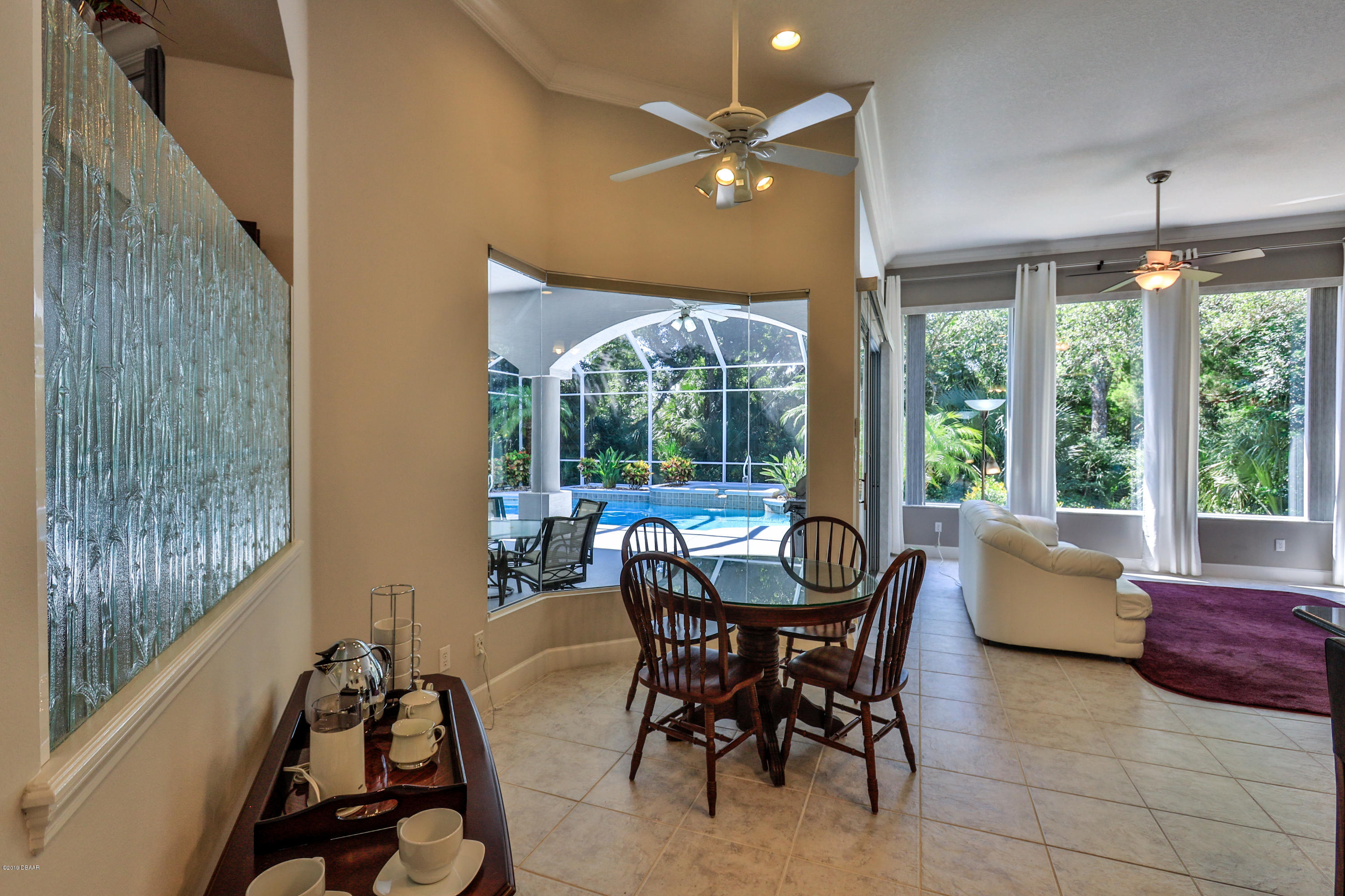 117 Beach Street Ponce Inlet, FL 32127 - Photo 21 of 37 a dining room with furniture and a large window