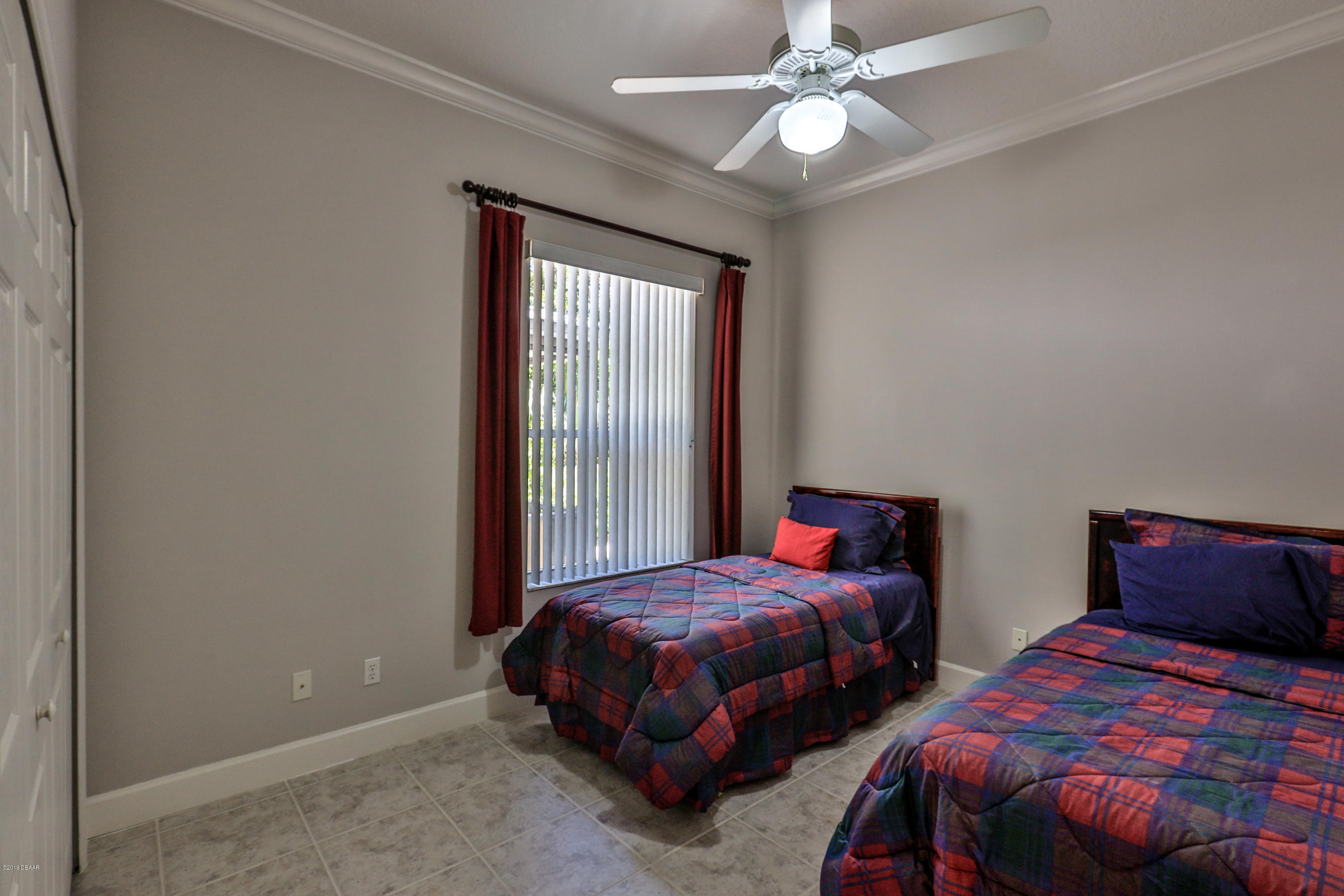 117 Beach Street Ponce Inlet, FL 32127 - Photo 24 of 37 a bedroom with two beds and a chandelier