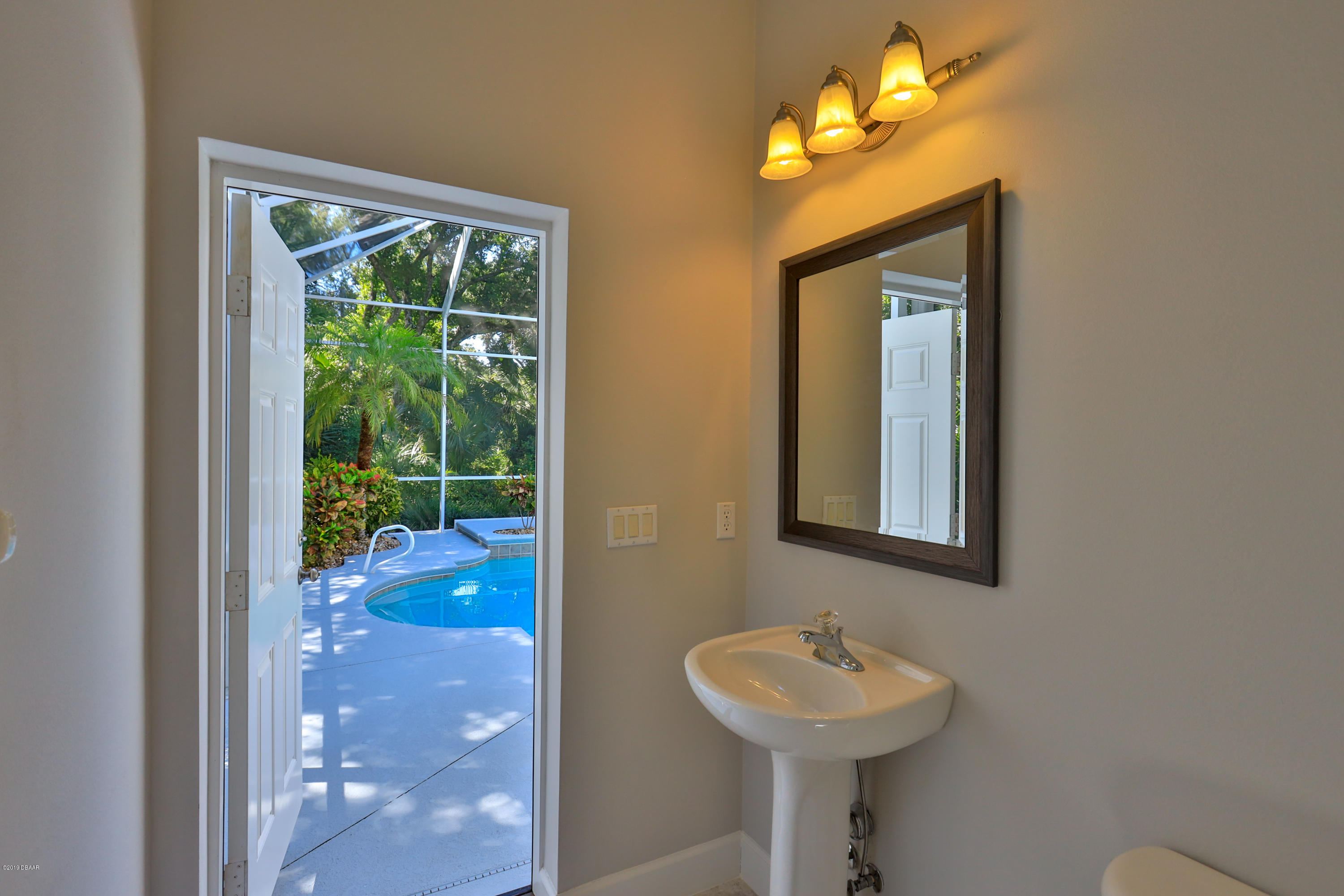 117 Beach Street Ponce Inlet, FL 32127 - Photo 9 of 37 a bathroom with a sink and a mirror