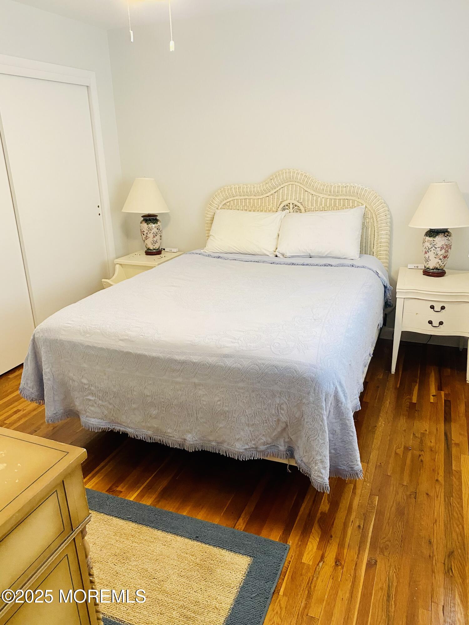 4 Camden Avenue, Unit UP Lavallette, NJ 08735 - Photo 3 of 10 a bedroom with a bed and wooden floor