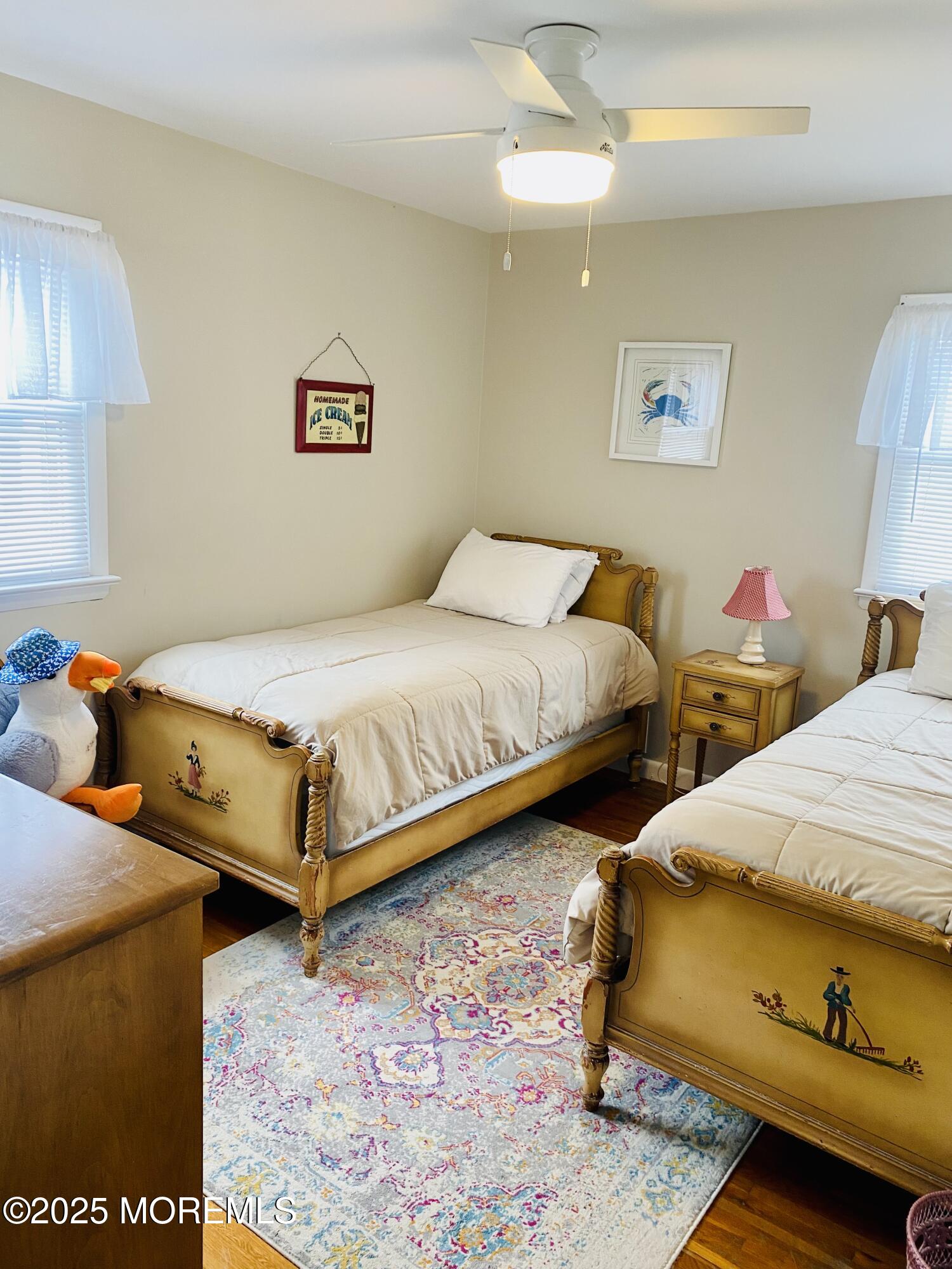 4 Camden Avenue, Unit UP Lavallette, NJ 08735 - Photo 6 of 10 a bedroom with two beds and a chandelier