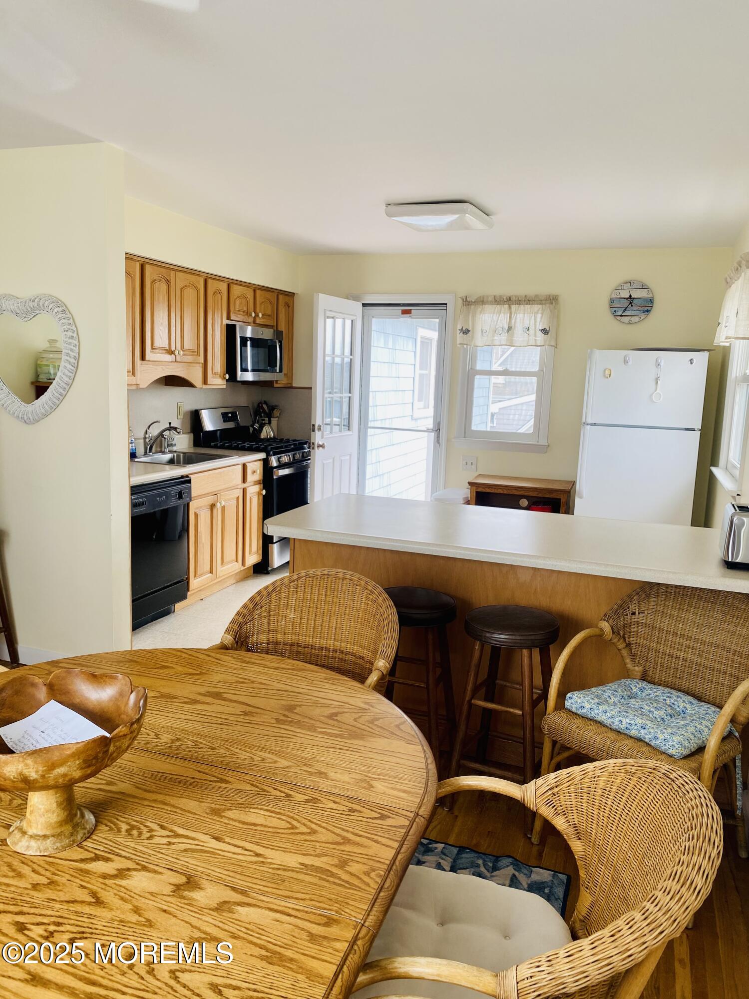 4 Camden Avenue, Unit UP Lavallette, NJ 08735 - Photo 8 of 10 a kitchen with stainless steel appliances kitchen island granite countertop a sink and cabinets