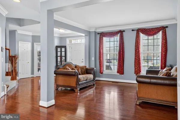 a living room with furniture wooden floor and a fireplace