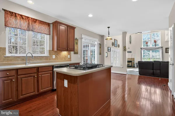 a spacious bathroom with a granite countertop sink toilet a large mirror and a window